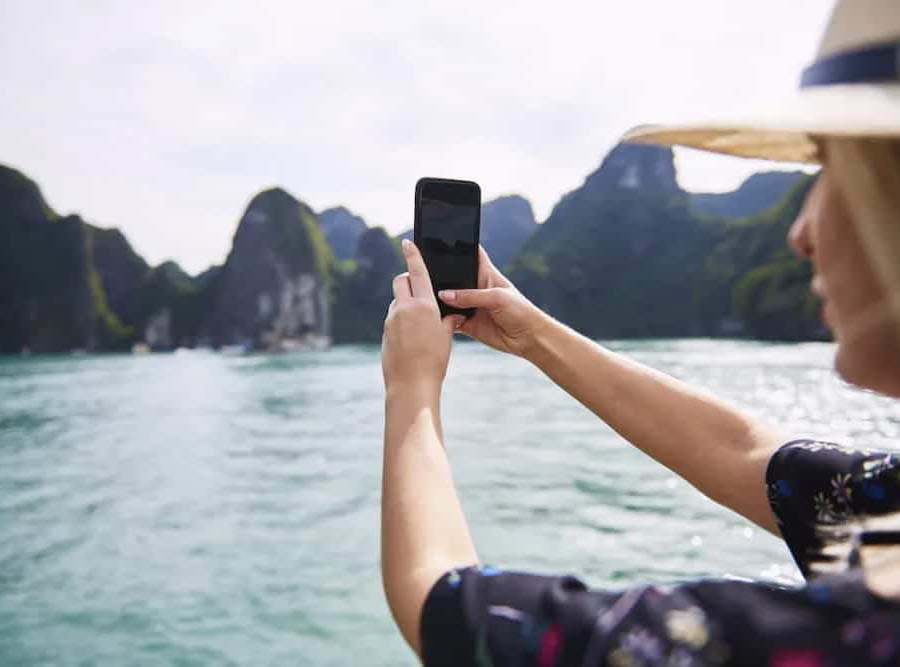 A traveler using his phone in Vietnam